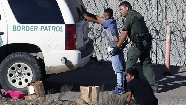 A Honduran teenager is taken into custody by U.S. Border Patrol agents crossing the U.S. near San Diego, Calif.