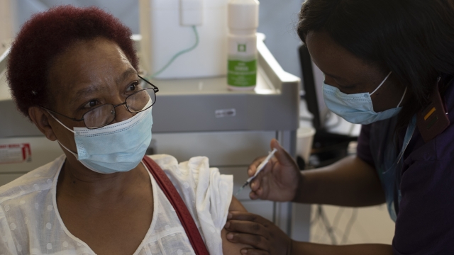 A woman receives the Johnson & Johnson COVID-19 vaccine from a health staff member at a vaccination center in South Africa.