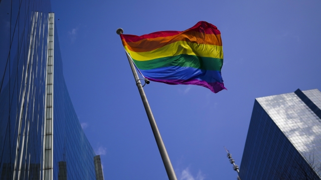 A rainbow flag flutters in the wind at the financial quarter in Brussels.