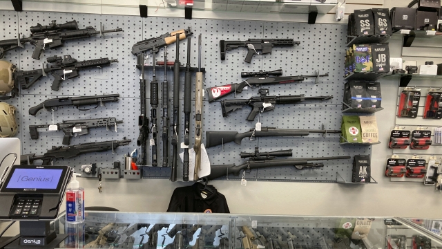 An assortment of rifles hang in a gun shop