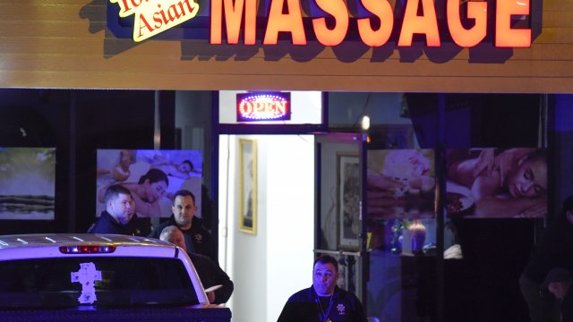Authorities investigate a fatal shooting at a massage parlor,