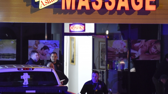 Authorities investigate a fatal shooting at a massage parlor