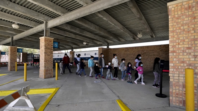 Migrants stand in line after being released from U.S. Customs and Border Protection custody at a bus station
