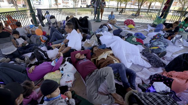 A group of migrants rest on a gazebo at a park after the deportees from the U.S. were pushed by Mexican authorities.
