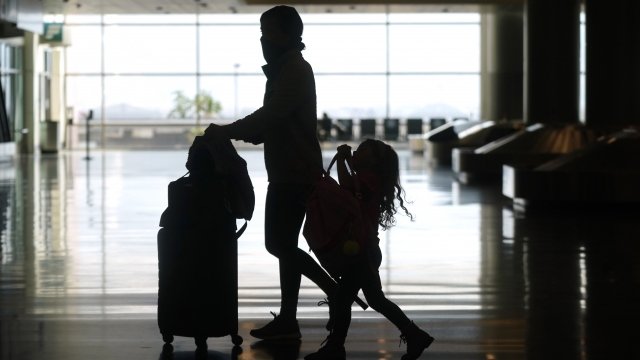 Travelers walk through the Salt Lake City International Airport