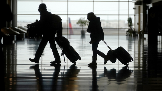 Travelers walk through the Salt Lake City International Airport,