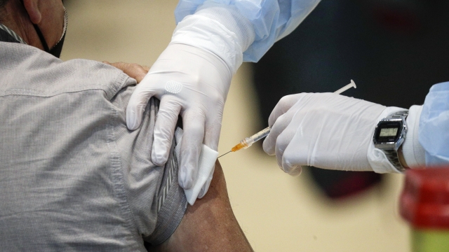 Medical staff administering a COVID-19 vaccination.