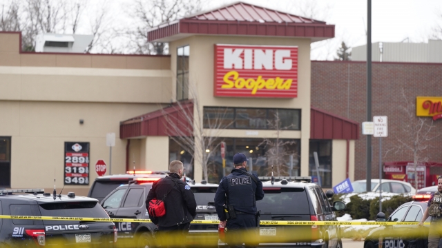 Police stand outside a King Soopers grocery store where a shooting took place in Boulder, Colorado