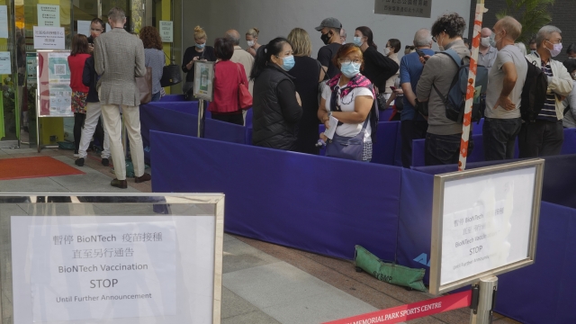 People lined up to receive the newly suspended Pfizer-BioNTech COVID-19 vaccine in Hong Kong, China..