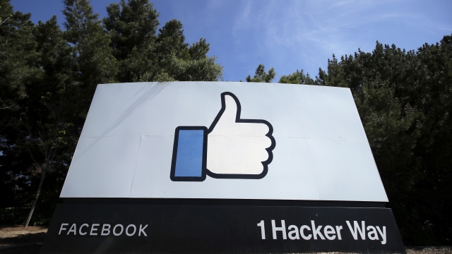 A "thumbs up" like logo is shown on a sign at Facebook HQ