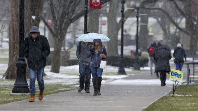 People walk in a snowfall at Rutgers University.