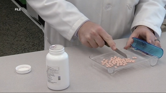 Pharmacist separates pills.