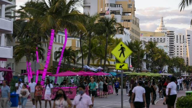 Tourists make their way down Ocean Drive during Spring Break in Miami Beach, Fla.