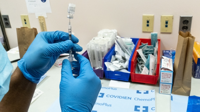 A pharmacist prepares a syringe with the Pfizer-BioNTech COVID-19 vaccine