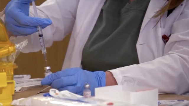 Health care worker prepares vaccine shot