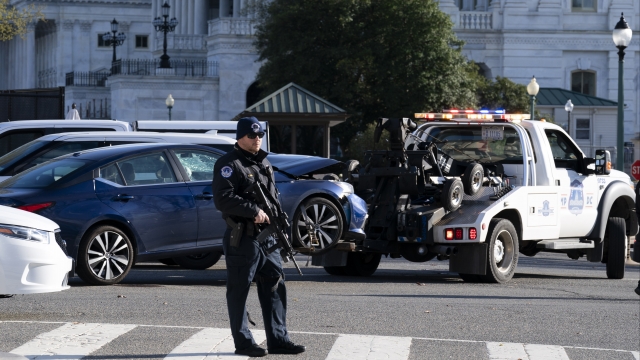 Authorities tow a car after a man rammed it into a barricade on Capitol Hill in Washington.