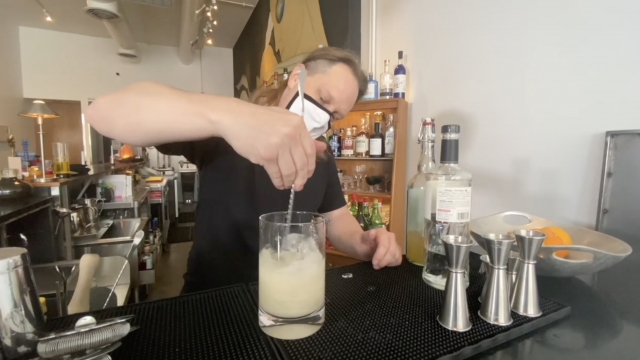 Bartender mixes a drink.