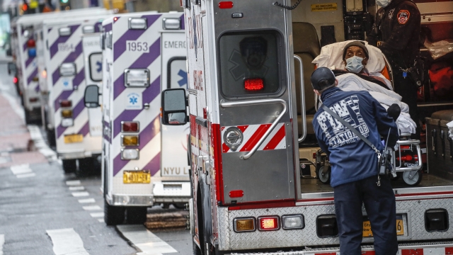 a patient arrives in an ambulance cared for by medical workers