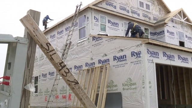 Man helps build a house.