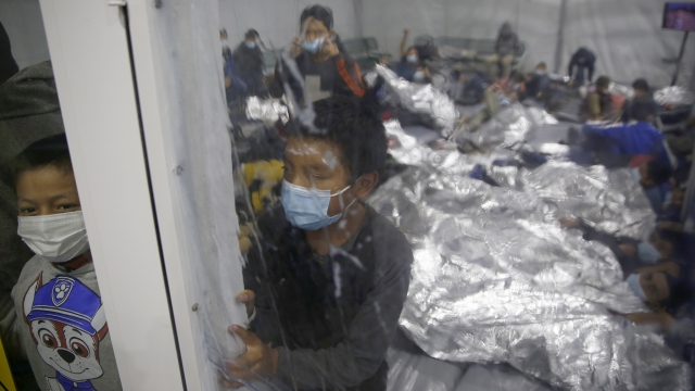 Children look out from inside a pod at the Donna Department of Homeland Security holding facility.