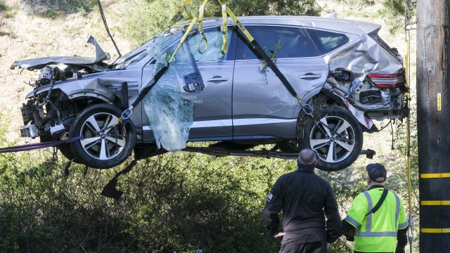 A crane lifts the vehicle in crash involving Tiger Woods