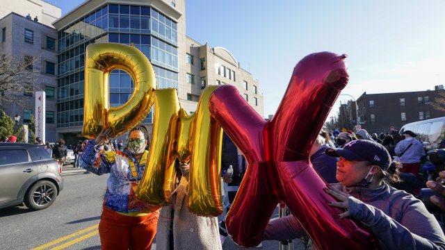Fans hold up "DMX" balloons during a prayer vigil outside of White Plains Hospital