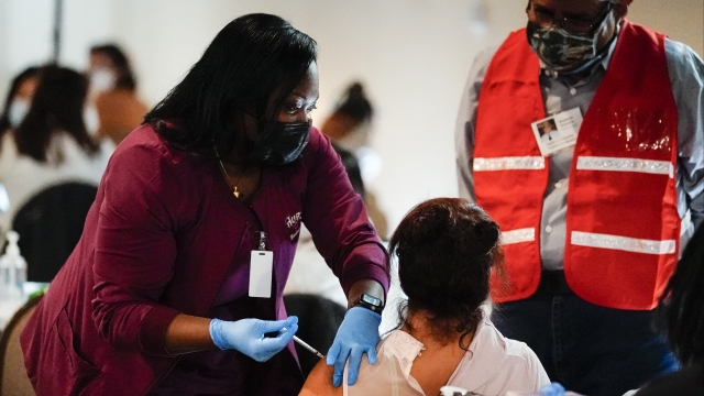 A health worker administers a dose of a Pfizer COVID-19 vaccine during a vaccination clinic in Philadelphia.