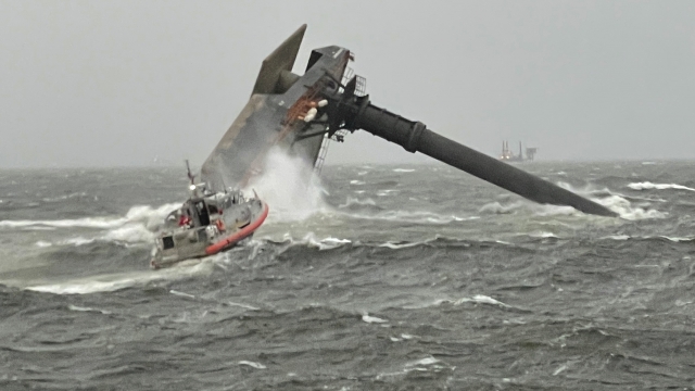A Coast Guard Station Grand Isle 45-foot Respone Boat-Medium boatcrew heads toward a capsized 175-foot commercial lift boat.