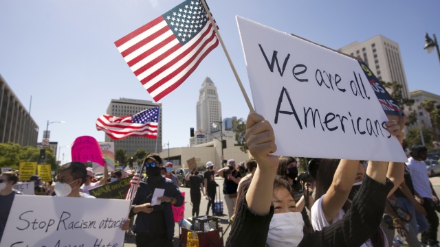 Protestors march at a rally against Asian hate crimes past the Los Angeles Federal Building