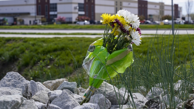 A single bouquet of flower sits in the rocks across the street from the FedEx facility in Indianapolis.