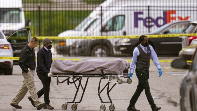 A body is taken from the scene where multiple people were shot at a FedEx Ground facility in Indianapolis