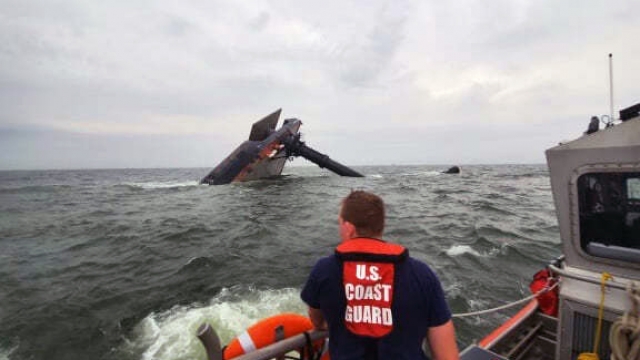 Coast Guard boat crew member search for survivors near the capsized Seacor Power