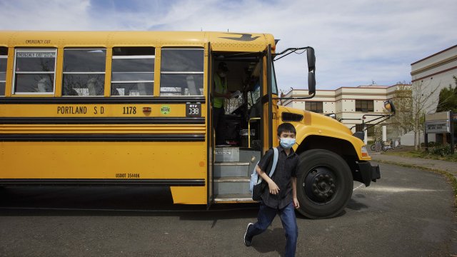 A student gets off a school bus