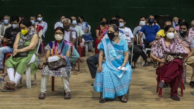 People wait to receive the COVAXIN vaccine for COVID-19 in India