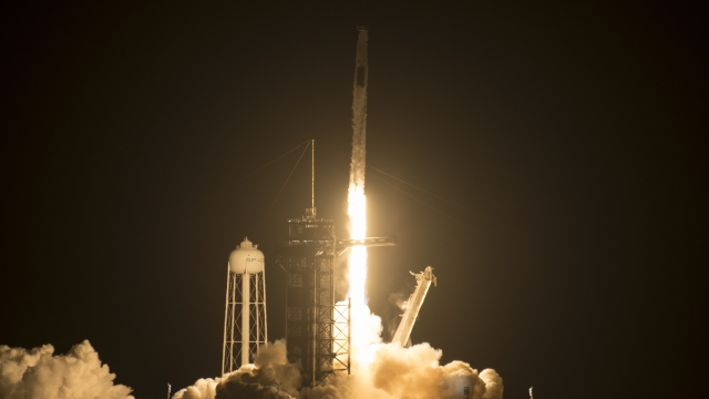 A SpaceX Falcon 9 rocket carrying the company's Crew Dragon spacecraft is launched.