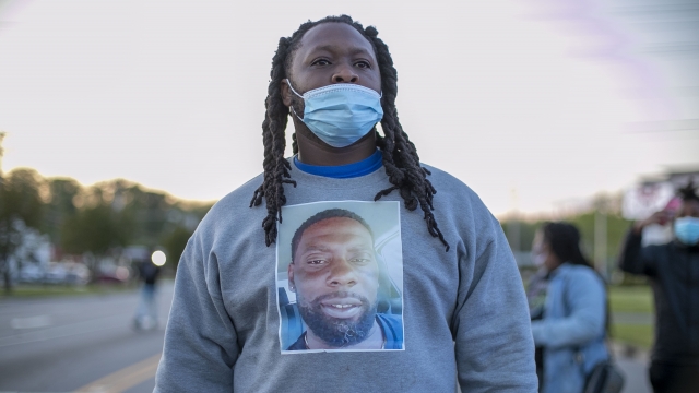A demonstrator wears a shirt with an image of Andrew Brown Jr.
