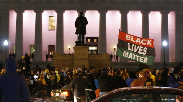 A crowd gathers in front of the Ohio Statehouse during a protest