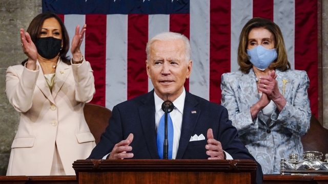 Vice President Kamala Harris, left, and House Speaker Nancy Pelosi of Calif., stand and applaud.