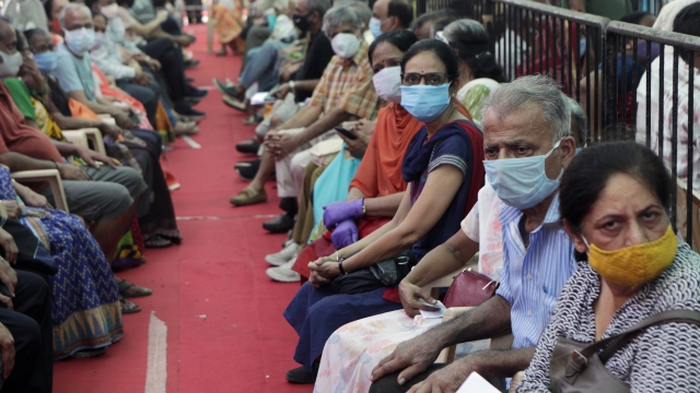 People wait to receive COVID-19 vaccine in Mumbai, India