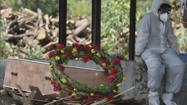 A wreath lies on the coffin of a COVID-19 victim before his cremation in Jammu, India.