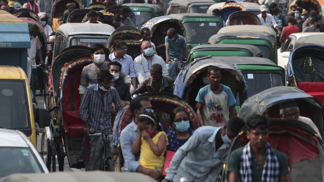 People crowded together at a busy marketplace in Dhaka, Bangladesh.