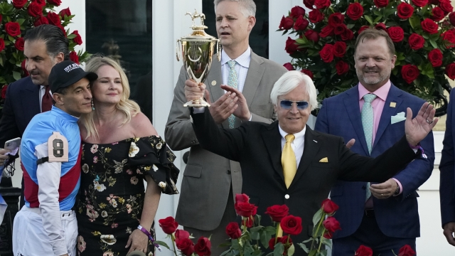 Horse trainer Bob Baffert holds up the winner's trophy at the 147th Kentucky Derby in Louisville, Kentucky