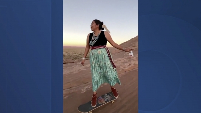 Woman skateboards in a desert