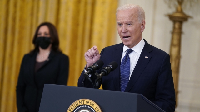 Vice President Kamala Harris listens as President Joe Biden speaks about the economy in the East Room of the White House.