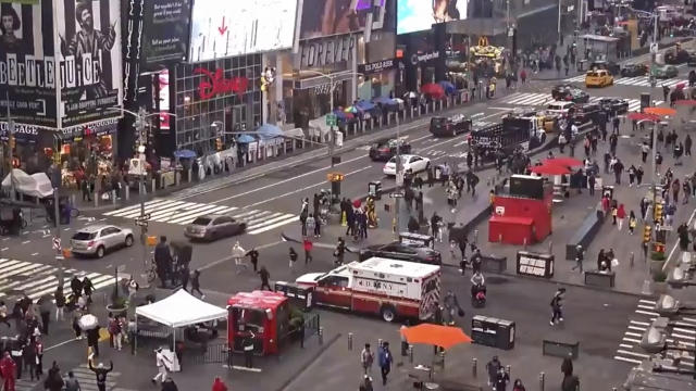 Pedestrians hurry away from the scene of a shooting in Times Square.