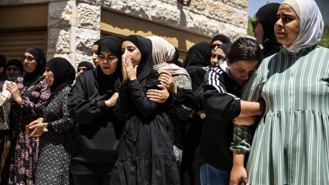 Mourners react during a funeral of a child killed during the attacks in Israel.