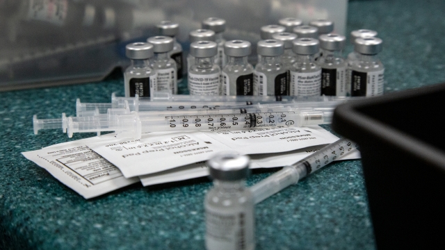 Doses of the Pfizer coronavirus vaccine are seen being prepared.