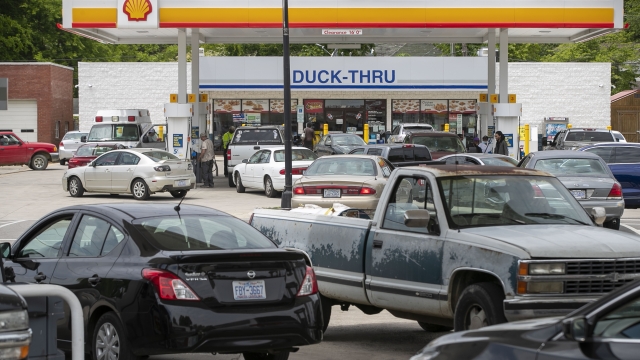 Customers fill up their vehicles with fuel at the Cupboard Food Store in Scotland Neck, N.C.