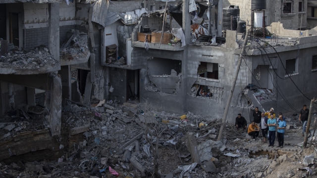 Palestinians inspect their destroyed houses following overnight Israeli airstrikes in northern Gaza Strip.