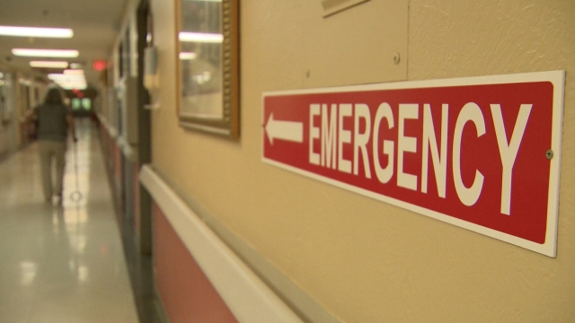 Emergency room sign hangs in the hall.